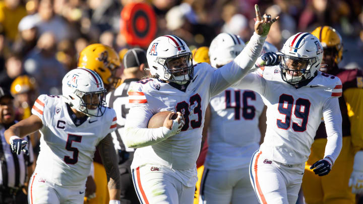 Nov 25, 2023; Tempe, Arizona, USA; Arizona Wildcats defensive lineman Jacob Kongaika (93) celebrates a fumble recovery with teammate Russell Davis II (99) against the Arizona State Sun Devils in the first half of the Territorial Cup at Mountain America Stadium