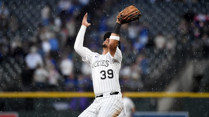 Jun 25, 2025; Denver, Colorado, USA; Colorado Rockies second base Thairo Estrada (39) loses the ball in the rain for a two RBI infield single during the sixth inning against the Los Angeles Dodgers at Coors Field