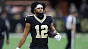 New Orleans Saints wide receiver Chris Olave (12) walks on the sideline during the second half at Caesars Superdome. 