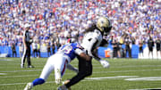 Sep 28, 2025; Orchard Park, New York, USA;  New Orleans Saints running back Alvin Kamara (41) is tackled by Buffalo Bills cornerback Dorian Strong (43) during the third quarter bat Highmark Stadium. Mandatory Credit: Gregory Fisher-Imagn Images