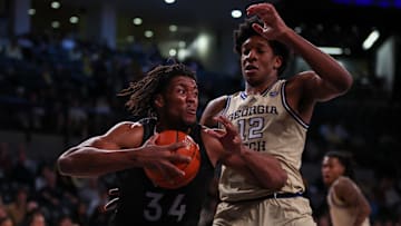 Jan 22, 2025; Atlanta, Georgia, USA; Virginia Tech Hokies forward Mylyjael Poteat (34) drives on Georgia Tech Yellow Jackets center Ryan Mutombo (12) in the first half at McCamish Pavilion. Mandatory Credit: Brett Davis-Imagn Images