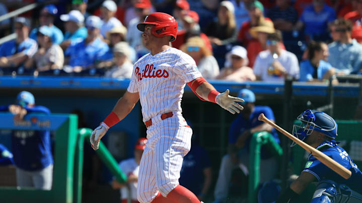 Mar 7, 2026; Clearwater, Florida, USA; Philadelphia Phillies first baseman Dylan Moore (25) singles during the sixth inning against the Toronto Blue Jays at BayCare Ballpark. Mandatory Credit: Kim Klement Neitzel-Imagn Images