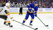 Mar 15, 2025; Buffalo, New York, USA;  Buffalo Sabres defenseman Bowen Byram (4) makes a pass as Vegas Golden Knights left wing Tanner Pearson (70) defends during the second period at KeyBank Center. Mandatory Credit: Timothy T. Ludwig-Imagn Images