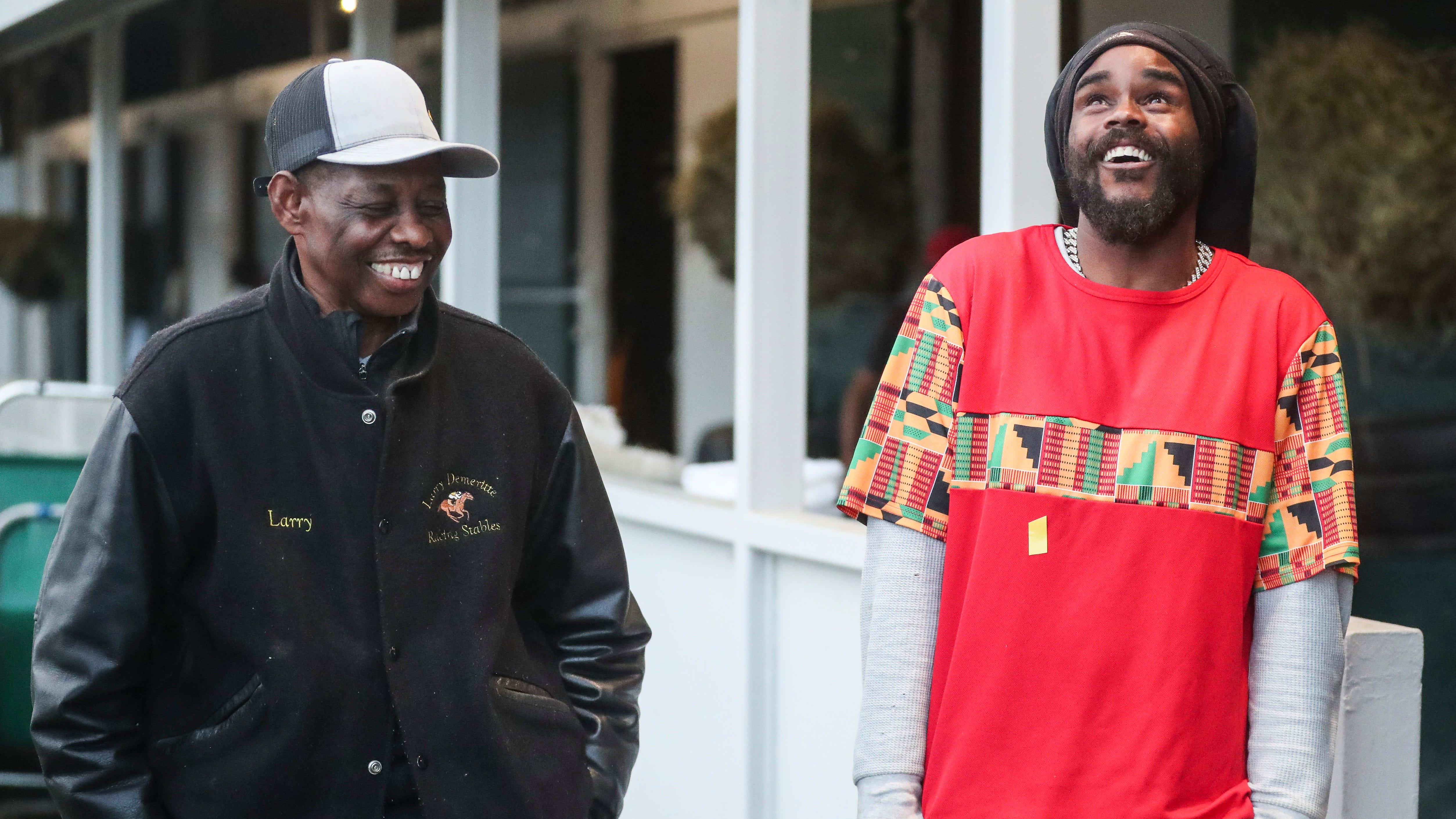 Demeritte and Lowery laugh together outside of the barn.