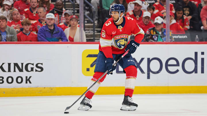 May 26, 2025; Sunrise, Florida, USA; Florida Panthers defenseman Seth Jones (3) controls the puck against the Carolina Hurricanes during the first period in game four of the Eastern Conference Final of the 2025 Stanley Cup Playoffs at Amerant Bank Arena. Mandatory Credit: Sam Navarro-Imagn Images