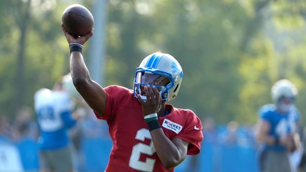 Detroit Lions quarterback Hendon Hooker throws downfield to a wide receiver during practice  