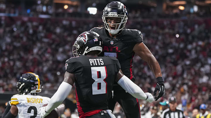 Sep 8, 2024; Atlanta, Georgia, USA; Atlanta Falcons tight end Kyle Pitts (8) reacts with running back Bijan Robinson (7) after catching a touchdown pass against the Pittsburgh Steelers during the first half at Mercedes-Benz Stadium. Mandatory Credit: Dale Zanine-Imagn Images