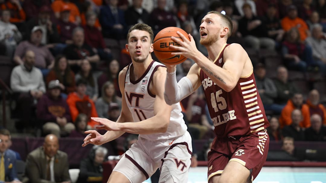 Feb 8, 2023; Blacksburg, Virginia, USA; Boston Colle Eagles guard Mason Madsen (45) drives to basket in front of Virginia Tech Hokies forward John Camden (11) in the first half at Cassell Coliseum. Mandatory Credit: Lee Luther Jr.-Imagn Images