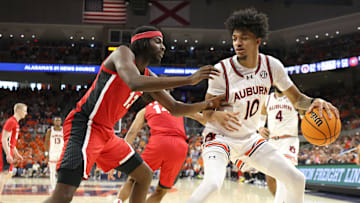 Feb 22, 2025; Auburn, Alabama, USA;  Georgia Bulldogs forward Dylan James (13) pressures Auburn Tigers guard Chad Baker-Mazara (10) during the second half at Neville Arena.  Mandatory Credit: John Reed-Imagn Images