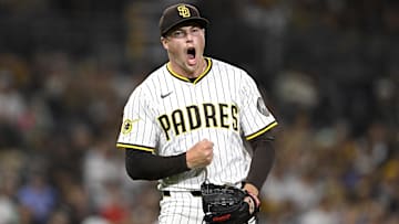 Sep 9, 2025; San Diego, California, USA; San Diego Padres relief pitcher Mason Miller (22) celebrates after striking out a batter during the eighth inning against the Cincinnati Reds at Petco Park. Mandatory Credit: Denis Poroy-Imagn Images
