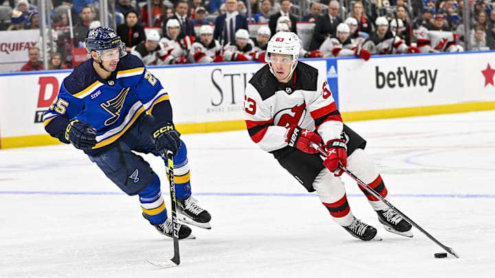 New Jersey Devils left wing Jesper Bratt (63) controls the puck as St. Louis Blues center Jordan Kyrou (25) defends: Jeff Curry-Imagn Images