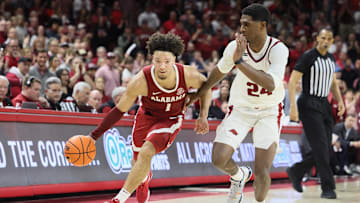 Feb 8, 2025; Fayetteville, Arkansas, USA; Alabama Crimson Tide guard Mark Sears (1) drives against Arkansas Razorbacks forward Billy Richmond III (24) during the second half at Bud Walton Arena. Alabama won 85-81. Mandatory Credit: Nelson Chenault-Imagn Images