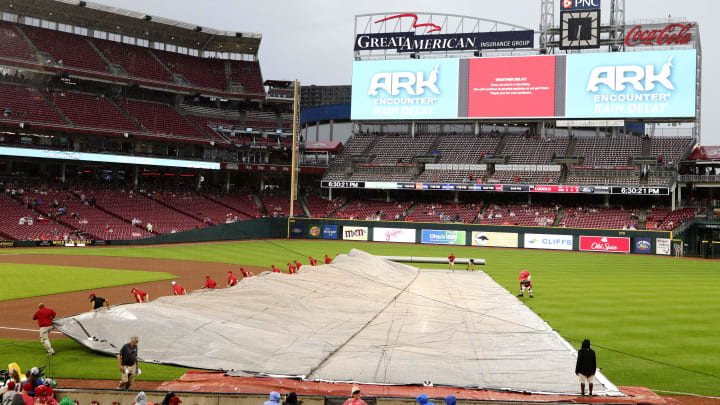 Sep 3, 2022; Cincinnati, Ohio, USA; The Cincinnati Reds grounds crew pull out the tarp during a