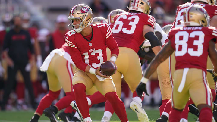 Aug 18, 2024; Santa Clara, California, USA; San Francisco 49ers quarterback Brock Purdy (13) holds onto the ball after taking a snap against the New Orleans Saints in the first quarter at Levi's Stadium. Mandatory Credit: Cary Edmondson-Imagn Images