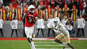 Nov 1, 2025; Raleigh, North Carolina, USA;  North Carolina State Wolfpack wide receiver Noah Rogers (5) catches a pass during the second quarter against Georgia Tech Yellow Jackets defensive back Rodney Shelley (6) at Carter-Finley Stadium. Mandatory Credit: Zachary Taft-Imagn Images