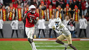 Nov 1, 2025; Raleigh, North Carolina, USA;  North Carolina State Wolfpack wide receiver Noah Rogers (5) catches a pass during the second quarter against Georgia Tech Yellow Jackets defensive back Rodney Shelley (6) at Carter-Finley Stadium. Mandatory Credit: Zachary Taft-Imagn Images