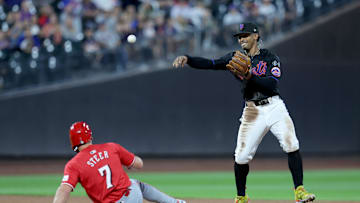 Sep 6, 2024; New York City, New York, USA; New York Mets shortstop Francisco Lindor (12) forces out Cincinnati Reds left fielder Spencer Steer (7) and second and throws to first to complete a double play on a ball hit by Reds center fielder TJ Friedl (29) during the second inning at Citi Field. Mandatory Credit: Brad Penner-Imagn Images