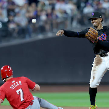 Sep 6, 2024; New York City, New York, USA; New York Mets shortstop Francisco Lindor (12) forces out Cincinnati Reds left fielder Spencer Steer (7) and second and throws to first to complete a double play on a ball hit by Reds center fielder TJ Friedl (29) during the second inning at Citi Field. Mandatory Credit: Brad Penner-Imagn Images