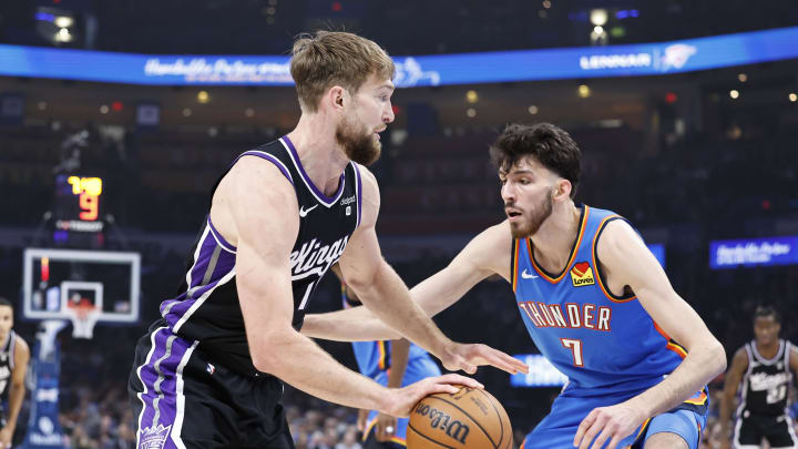 Apr 9, 2024; Oklahoma City, Oklahoma, USA; Sacramento Kings forward Domantas Sabonis (10) drives to the basket as Oklahoma City Thunder forward Chet Holmgren (7) defends during the first quarter at Paycom Center. Mandatory Credit: Alonzo Adams-USA TODAY Sports