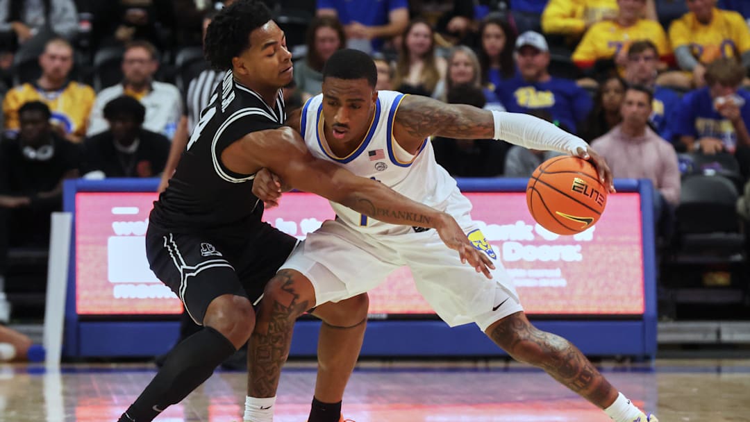 Oct 19, 2025; Pittsburgh, PA, USA;  Providence Friars guard Corey Floyd Jr. (14) defends against Pittsburgh Panthers guard Damarco Minor (7) during the second half at the Petersen Events Center. Mandatory Credit: Charles LeClaire-Imagn Images