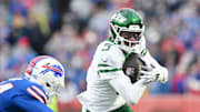 Dec 29, 2024; Orchard Park, New York, USA; New York Jets wide receiver Garrett Wilson (5) tries to get past Buffalo Bills safety Cole Bishop (24) after making a catch in the second quarter at Highmark Stadium. Mandatory Credit: Mark Konezny-Imagn Images
