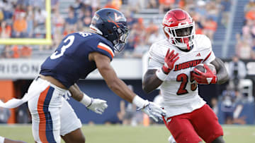 Oct 12, 2024; Charlottesville, Virginia, USA; Louisville Cardinals running back Isaac Brown (25) carries the ball past Virginia Cavaliers safety Corey Thomas Jr. (3) to score a touchdown during the second half at Scott Stadium. Mandatory Credit: Amber Searls-Imagn Images