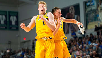 Michigan Wolverines center Danny Wolf (1) celebrates with forward Will Tschetter (42) during the first half of the Fort Myers Tip-Off Beach Division final against the Xavier Musketeers at Suncoast Credit Union Arena in Fort Myers, Fla., on Wednesday, Nov. 27, 2024.