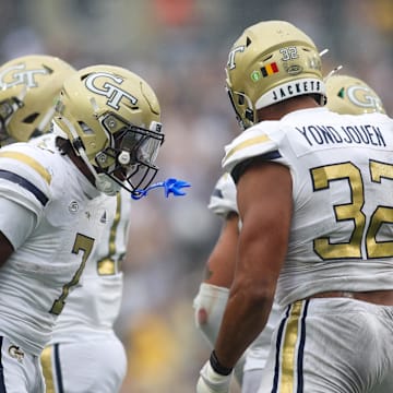 Sep 14, 2024; Atlanta, Georgia, USA; Georgia Tech Yellow Jackets defensive lineman Sylvain Yondjouen (32) celebrates with defensive back Taye Seymore (7) after a sack against the Virginia Military Institute Keydets in the second quarter at Bobby Dodd Stadium at Hyundai Field. Mandatory Credit: Brett Davis-Imagn Images