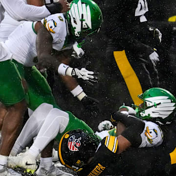 Oregon Ducks running back Dierre Hill Jr. (23) is tackled in the endzone by Iowa Hawkeyes defensive back Xavier Nwankpa (1) Nov. 8, 2025 during a Big Ten Football game at Kinnick Stadium in Iowa City, Iowa.