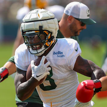 Green Bay Packers running back Josh Jacobs (8) runs through a ball-security drill during training camp.