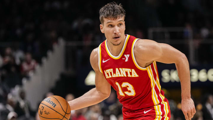 Apr 10, 2024; Atlanta, Georgia, USA; Atlanta Hawks guard Bogdan Bogdanovic (13) controls the ball against the Charlotte Hornets during the first half at State Farm Arena. Mandatory Credit: Dale Zanine-USA TODAY Sports