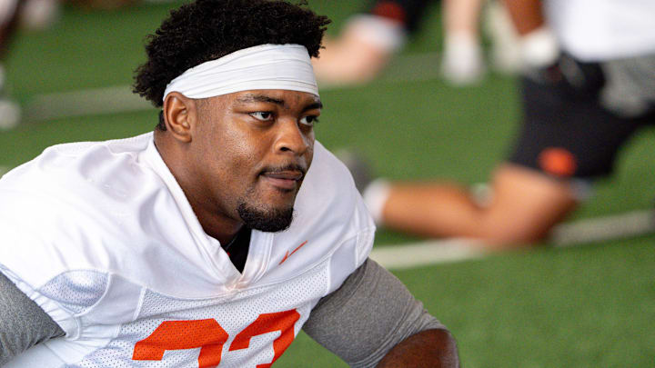 Obi Ezeigbo (33) stretches out during an Oklahoma State football practice in Stillwater, Okla., on Saturday, Aug. 3, 2024.