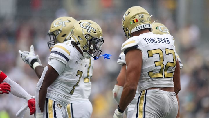 Sep 14, 2024; Atlanta, Georgia, USA; Georgia Tech Yellow Jackets defensive lineman Sylvain Yondjouen (32) celebrates with defensive back Taye Seymore (7) after a sack against the Virginia Military Institute Keydets in the second quarter at Bobby Dodd Stadium at Hyundai Field. Mandatory Credit: Brett Davis-Imagn Images