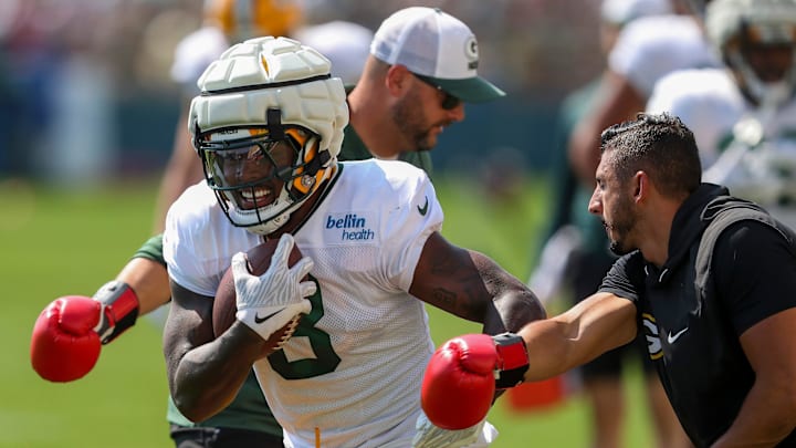 Green Bay Packers running back Josh Jacobs (8) runs through a ball-security drill during training camp.