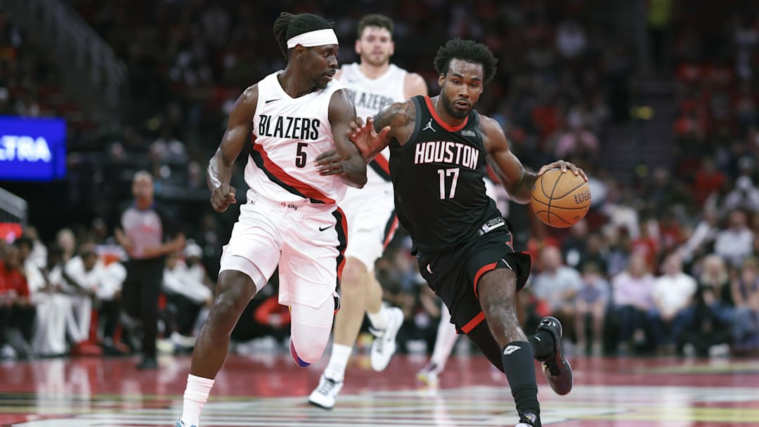 Nov 14, 2025; Houston, Texas, USA;  Houston Rockets forward Tari Eason (17) drives with the ball as Portland Trail Blazers guard Jrue Holiday (5) defends during the second quarter at Toyota Center. Mandatory Credit: Troy Taormina-Imagn Images