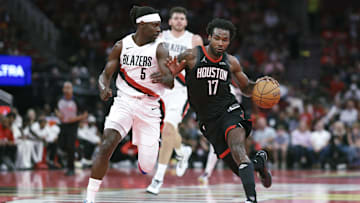 Nov 14, 2025; Houston, Texas, USA;  Houston Rockets forward Tari Eason (17) drives with the ball as Portland Trail Blazers guard Jrue Holiday (5) defends during the second quarter at Toyota Center. Mandatory Credit: Troy Taormina-Imagn Images