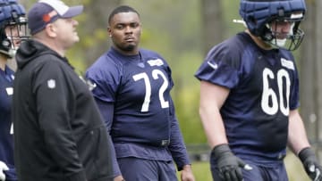 Kiran Amegadjie talks to offensive line coach Chris Morgan during Bears rookie minicamp. Amegadjie is out when practice starts..