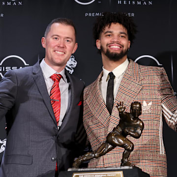 Dec 10, 2022; New York, NY, USA; Southern California quarterback Caleb Williams (right) poses for photos with his head coach Lincoln Riley during a press conference in the Astor Ballroom at the New York Marriott Marquis in New York, NY, after winning the 2022 Heisman Trophy. Mandatory Credit: Brad Penner-Imagn Images