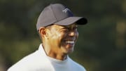 Apr 8, 2024; Augusta, Georgia, USA; Tiger Woods smiles as he walks on the practice green during a practice round for the Masters Tournament golf tournament at Augusta National Golf Club. Mandatory Credit: Kyle Terada-USA TODAY Network