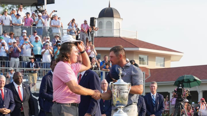 Jun 16, 2024; Pinehurst, North Carolina, USA; Bryson DeChambeau shakes hands with low amateur winner Neal Shipley after winning the U.S. Open golf tournament. Mandatory Credit: Jim Dedmon-USA TODAY Sports