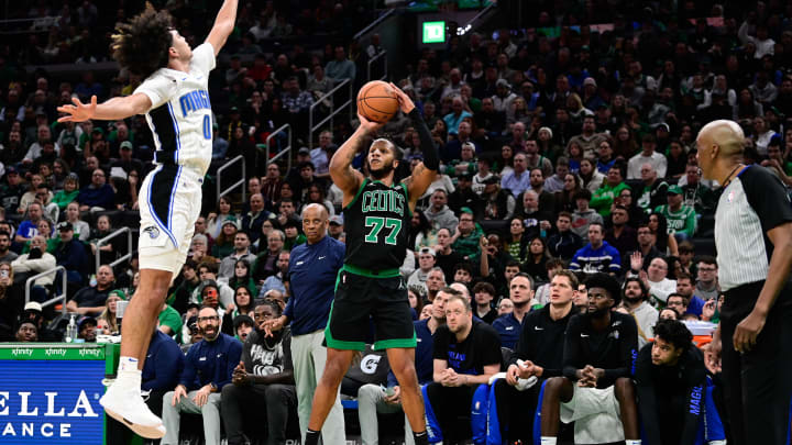 Dec 15, 2023; Boston, Massachusetts, USA; Boston Celtics forward Lamar Stevens (77) shoots the ball while being defended by Orlando Magic guard Anthony Black (0) during the second half at TD Garden. Mandatory Credit: Eric Canha-USA TODAY Sports