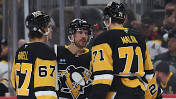 Pittsburgh Penguins forwards Rickard Rakell, Sidney Crosby and Evgeni Malkin