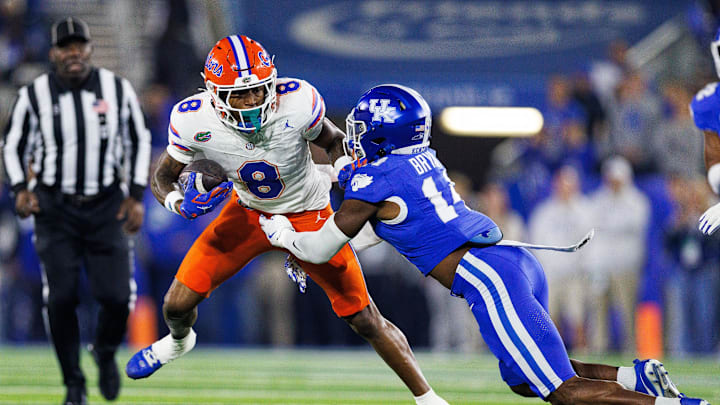 Nov 8, 2025; Lexington, Kentucky, USA; Florida Gators wide receiver Vernell Brown III (8) runs the ball against Kentucky Wildcats defensive back Ty Bryant (14) during the first quarter at Kroger Field. Mandatory Credit: Jordan Prather-Imagn Images