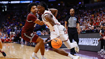 Mar 20, 2025; Denver, CO, USA; Wisconsin Badgers guard John Blackwell (25) dribbles the ball against Montana Grizzlies guard Brandon Whitney (12) during the first half in the first round of the NCAA Tournament at Ball Arena.