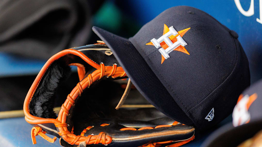 Apr 27, 2025; Kansas City, Missouri, USA; Houston Astros hat and glove in the dugout during the second inning against the Kansas City Royals at Kauffman Stadium. 