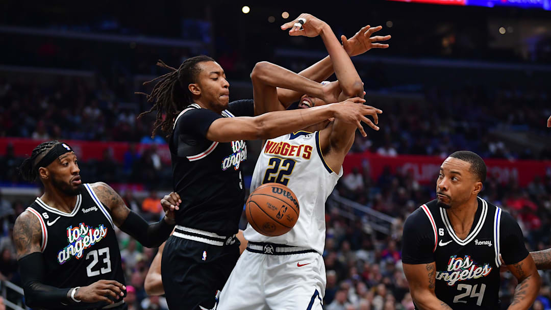 January 13, 2023; Los Angeles, California, USA; Los Angeles Clippers center Moses Brown (9) plays for the ball against Denver Nuggets forward Zeke Nnaji (22) during the second half at Crypto.com Arena. Mandatory Credit: Gary A. Vasquez-Imagn Images