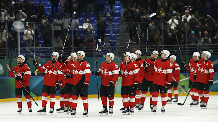 Feb 12, 2026; Milan, Italy; Athletes of Switzerland celebrate after the match during a Group A men's ice hockey game during the Milano Cortina 2026 Olympic Winter Games at Milano Santagiulia Ice Hockey Arena. Mandatory Credit: Geoff Burke-Imagn Images