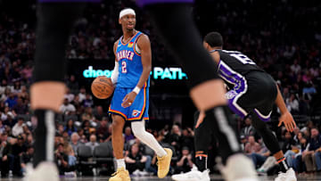 Mar 25, 2025; Sacramento, California, USA; Oklahoma City Thunder guard Shai Gilgeous-Alexander (2) dribbles the ball next to Sacramento Kings forward Keegan Murray (13) in the third quarter at the Golden 1 Center. Mandatory Credit: Cary Edmondson-Imagn Images