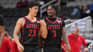 Dec 21, 2024; San Jose, California, USA; San Diego State Aztecs guards Kimo Ferrari (23) and Wayne McKinney III (3) talk during the second half against the California Golden Bears at SAP Center.