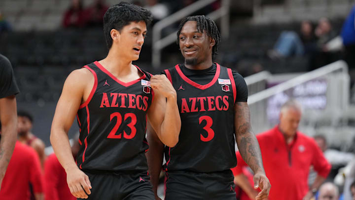 Dec 21, 2024; San Jose, California, USA; San Diego State Aztecs guards Kimo Ferrari (23) and Wayne McKinney III (3) talk during the second half against the California Golden Bears at SAP Center. Mandatory Credit: Darren Yamashita-Imagn Images Dec 21, 2024; San Jose, California, USA; San Diego State Aztecs guards Kimo Ferrari (23) and Wayne McKinney III (3) talk during the second half against the California Golden Bears at SAP Center. Mandatory Credit: Darren Yamashita-Imagn Images